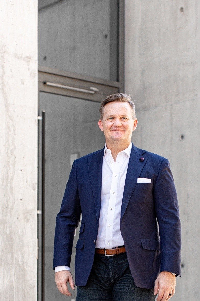 Nick Kennedy standing in a navy suit